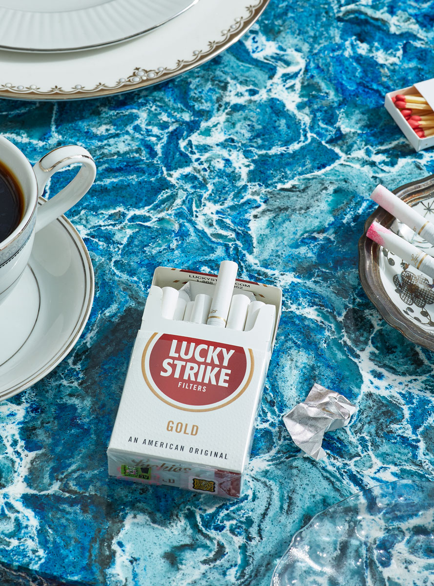 Lucky Strike Cigarettes in a pack on blue marble