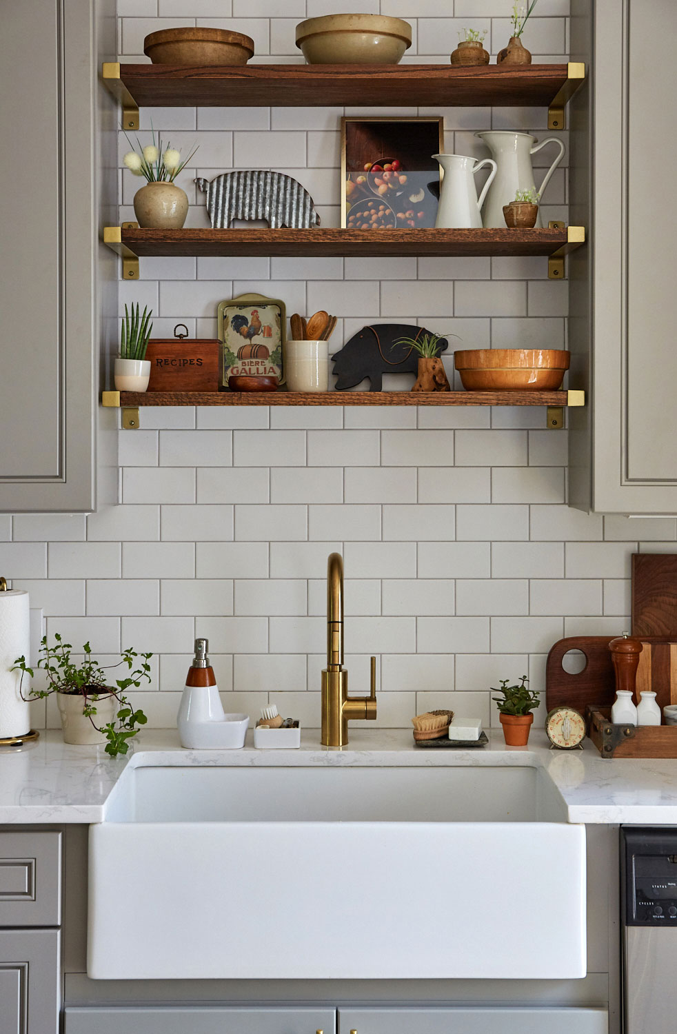Kitchen sink with white tile and brass fixtures