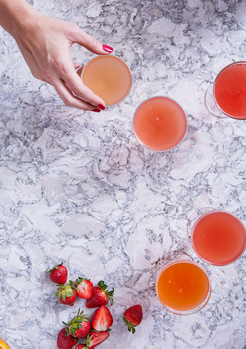 Hand reaching for Kombucha Mimosas