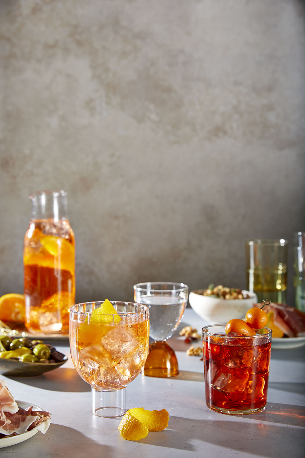 Negroni & Aperol drinks on a table with snacks