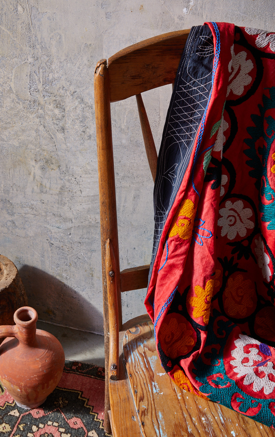 Red turkish throw on wood chair