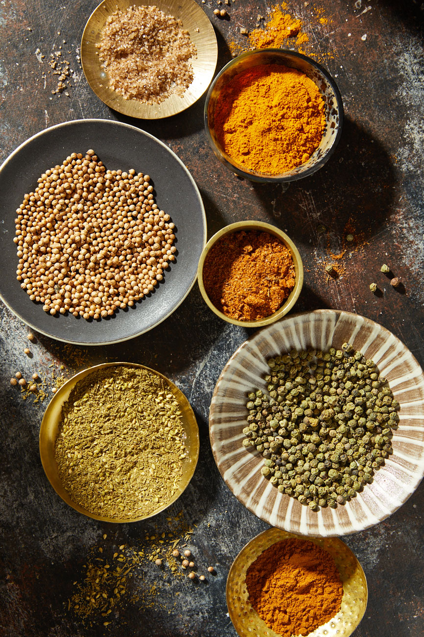 Spices in bowls on metal surface