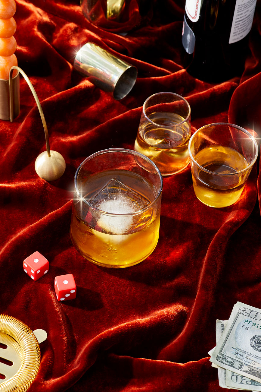 Whiskeyon the Rocks with cash and dice on red velvet